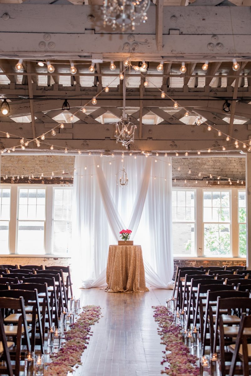 Indoor spring wedding ceremony at the event venue The Stockroom at 230 in Raleigh, North Carolina. Their photographer, Mikkel Paige Photography, captured the bride and groom’s vows in this historic building near the capital downtown. #MikkelPaige #DowntownRaleigh #RaleighWedding #RaleighVenue #TheStockroomat230 #weddingceremony #indoorweddingceremony