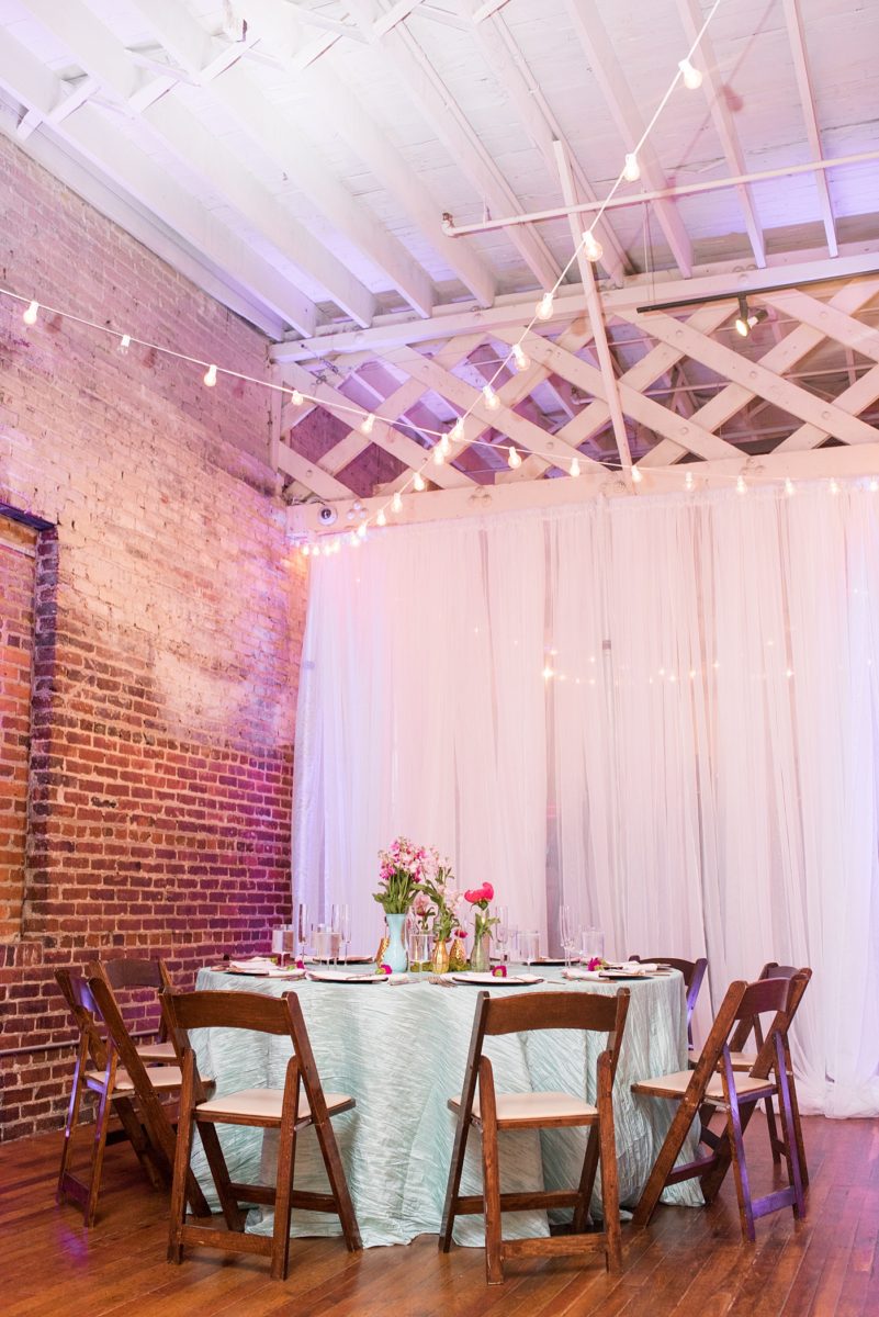 A beautiful spring wedding in downtown Raleigh, North Carolina, at the event venue The Stockroom at 230. Mikkel Paige Photography, their photographer, captured inspiring reception pictures of their hot pink and aqua blue colors. #MikkelPaige #DowntownRaleigh #RaleighWedding #RaleighVenue #TheStockroomat230 #weddingreception