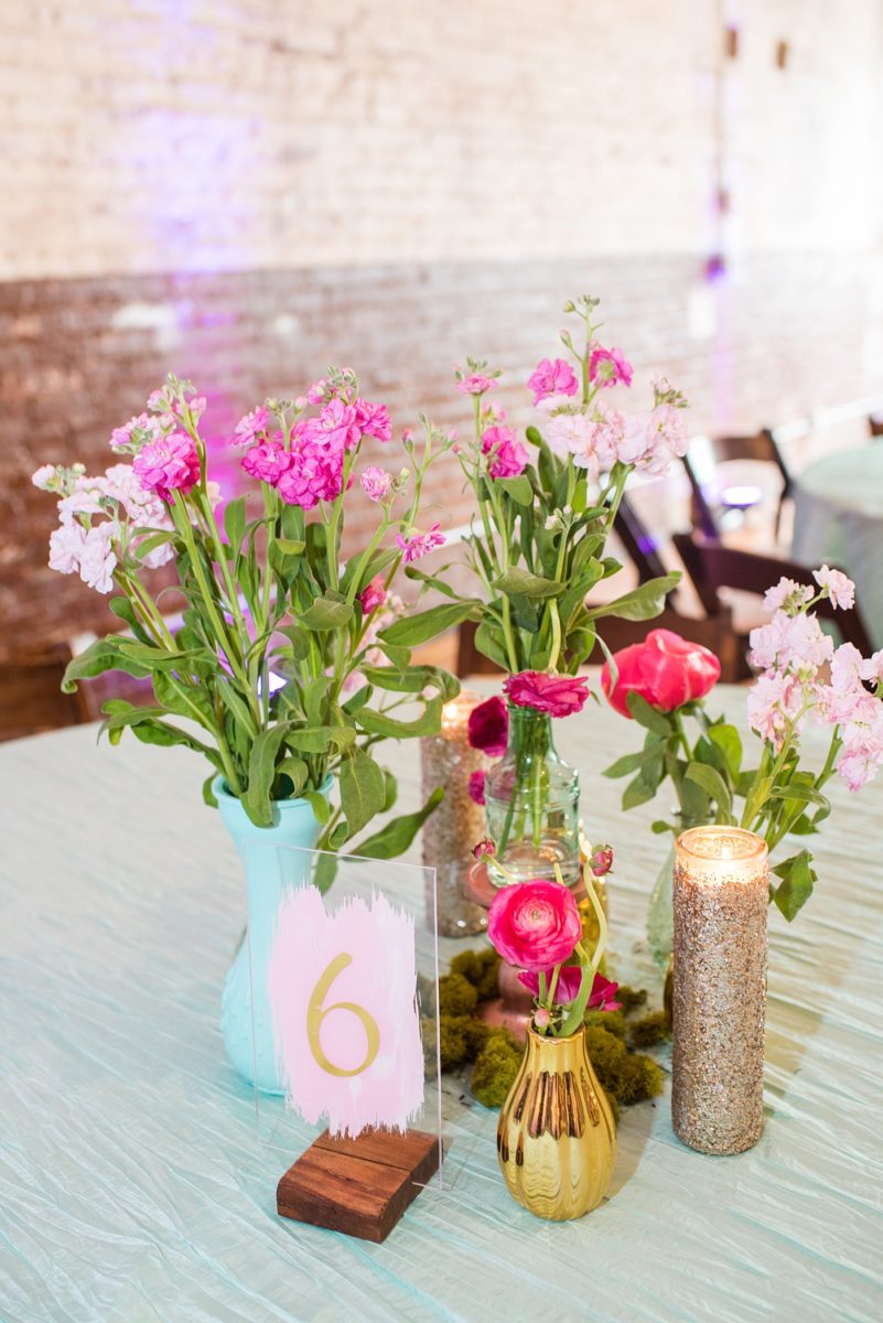 A beautiful spring wedding in downtown Raleigh, North Carolina, at the event venue The Stockroom at 230. Mikkel Paige Photography, their photographer, captured inspiring reception pictures of their hot pink and aqua blue colors. #MikkelPaige #DowntownRaleigh #RaleighWedding #RaleighVenue #TheStockroomat230 #weddingreception
