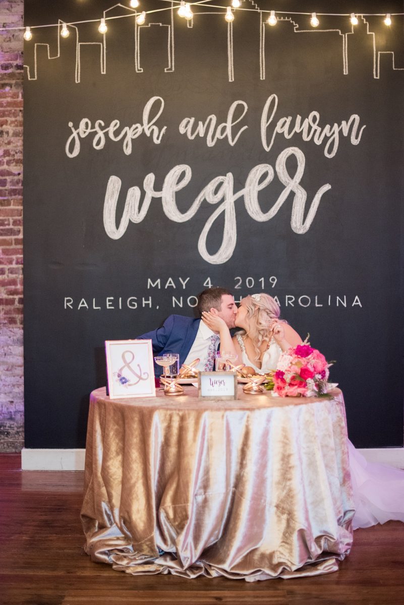 A beautiful spring wedding in downtown Raleigh, North Carolina, at the event venue The Stockroom at 230. Mikkel Paige Photography, their photographer, captured inspiring reception pictures of their hot pink and aqua blue colors. #MikkelPaige #DowntownRaleigh #RaleighWedding #RaleighVenue #TheStockroomat230 #weddingreception #chalkboardwall