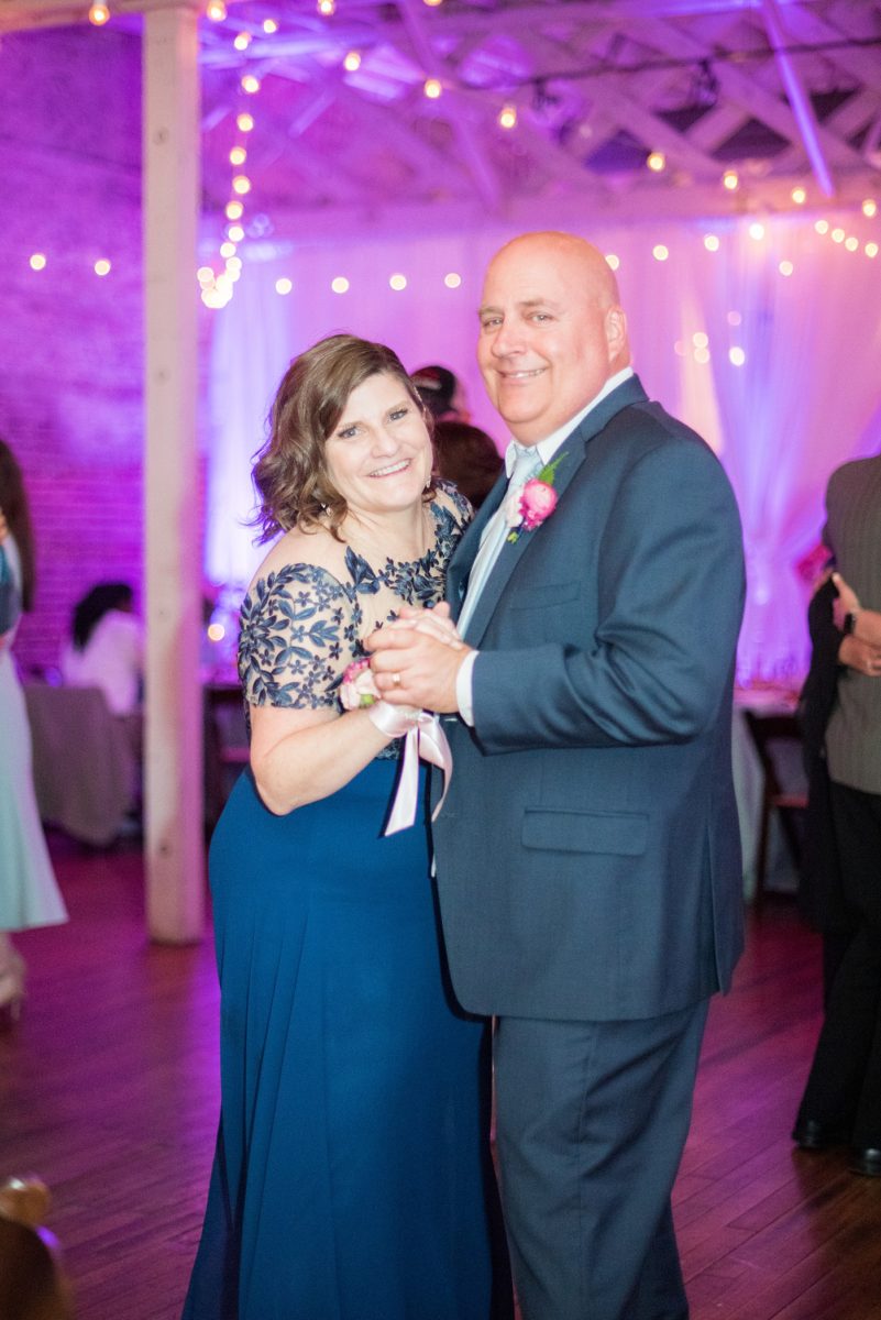 A beautiful spring wedding in downtown Raleigh, North Carolina, at the event venue The Stockroom at 230. Mikkel Paige Photography, their photographer, captured inspiring reception pictures of their hot pink and aqua blue colors. #MikkelPaige #DowntownRaleigh #RaleighWedding #RaleighVenue #TheStockroomat230 #weddingreception