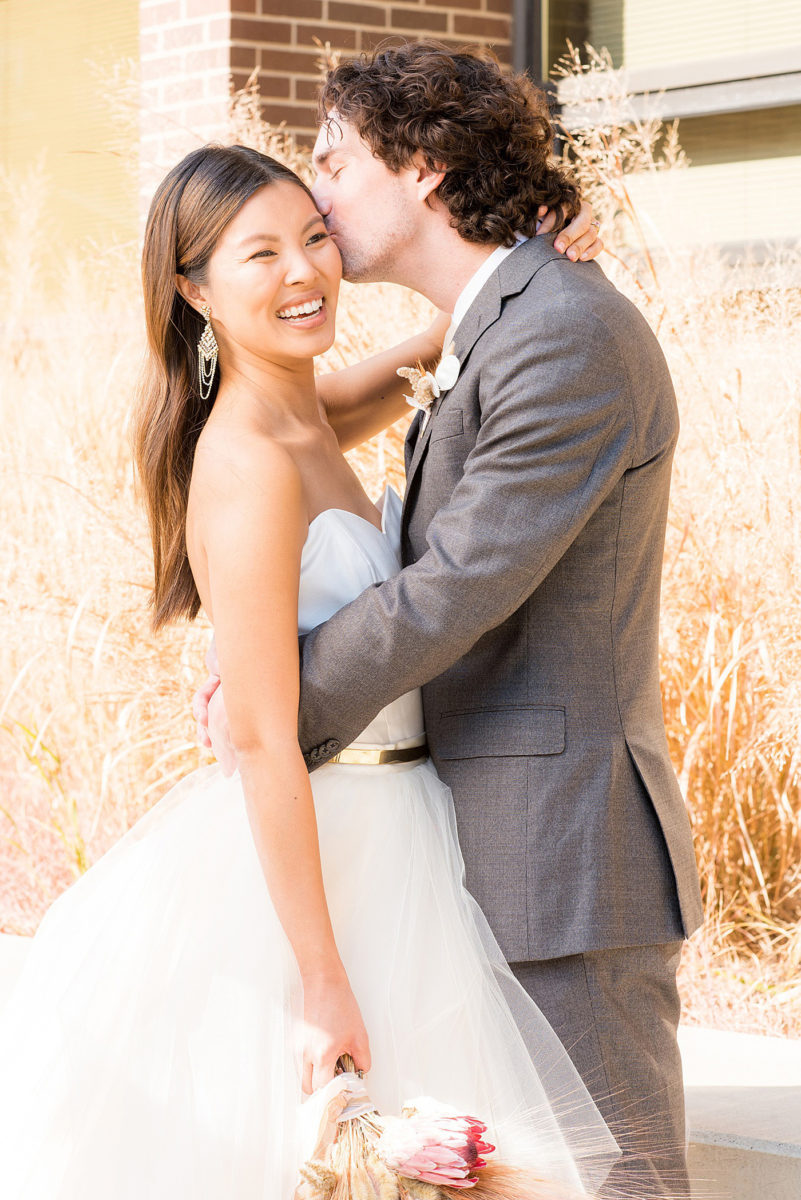 Downtown wedding venue photos by Mikkel Paige Photography in the city of Raleigh, North Carolina. The beautiful Canon Room is historically named and great for an indoor ceremony and reception. Portraits of the bride + groom, bouquet with chic and rustic dried flowers. The neutral color decor will inspire you with unique wedding ideas. #mikkelpaige #downtownRaleigh #raleighwedding #downtownraleighweddingvenue #ncwedding #raleighwedding #raleighweddingphotographer #raleighweddingphotographs