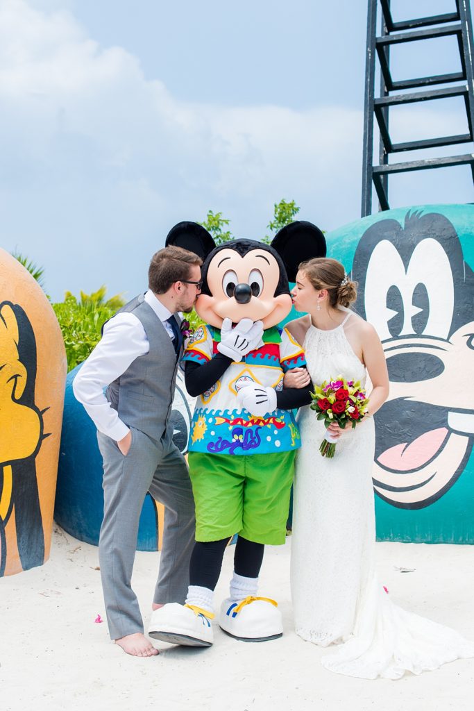 Disney Cruise Line destination wedding photos on Castaway Cay and the Disney Dream ship by Mikkel Paige Photography. This fairy tale wedding made the bride and groom's dream come true to get married in a fun location, spotlighting their love for Disney. Their ceremony was on the beach with the ship in the distance and aqua water nearby in the Bahamas and Mickey Mouse as a special guest. #mikkelpaige #disneywedding #disneyfairytalewedding #disneycruiseline #disneycruiselinewedding #disneydream #cruisewedding #mickeymouse