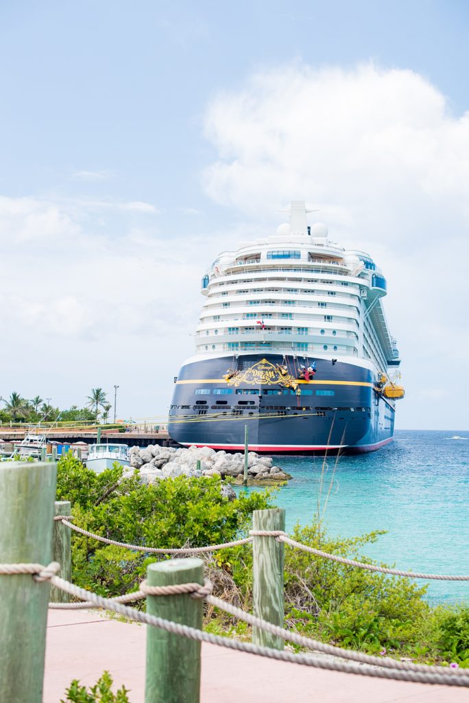 Disney Cruise Line destination wedding photos on Castaway Cay and the Disney Dream ship by Mikkel Paige Photography. This fairy tale wedding made the bride and groom's dream come true to get married in a fun location, spotlighting their love for Disney. Their ceremony was on the beach with the ship in the distance and aqua water nearby in the Bahamas and Mickey Mouse as a special guest. #mikkelpaige #disneywedding #disneyfairytalewedding #disneycruiseline #disneycruiselinewedding #disneydream #cruisewedding #disneydreamship