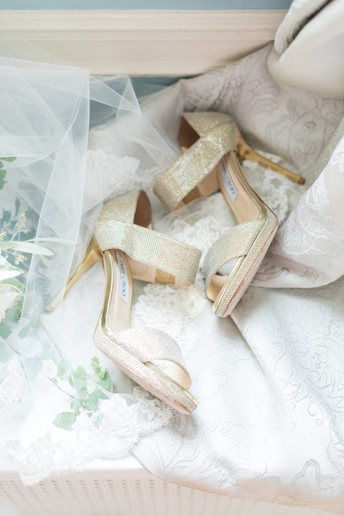 Westchester wedding photography at a beautiful outdoor and indoor venue called Crabtree's Kittle House. Photos by Mikkel Paige Photography. The bride style included gold glitter Jimmy Choo shoes, laid out in this lay flat photo with her veil. #mikkelpaige #westchestervenue #westchesterphotography #crabtreeskittlehouse #weddingshoes #jimmychoo #glitterheels #layflatphotography #summerwedding