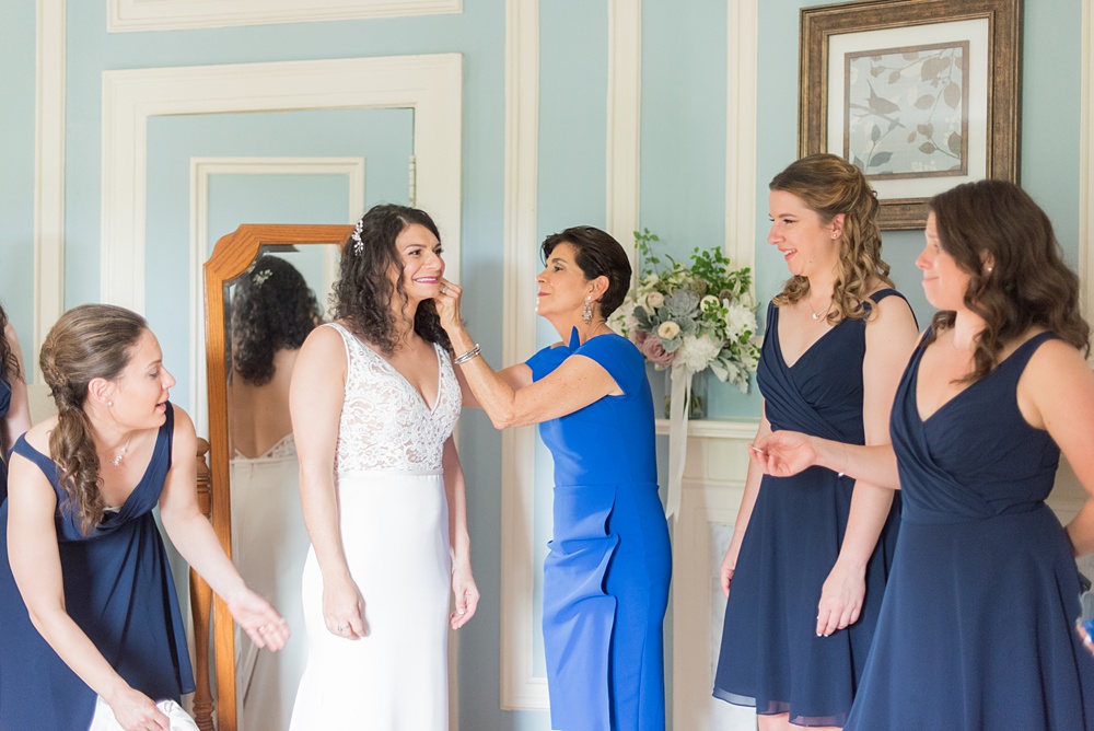 Westchester wedding photography at a beautiful outdoor and indoor venue called Crabtree's Kittle House. Photos by Mikkel Paige Photography. The bride style included a v-neck lace gown that her mother and bridesmaids helped her prepare for her May celebration. #mikkelpaige #westchestervenue #westchesterphotography #crabtreeskittlehouse #bridestyle #gettingready #summerwedding