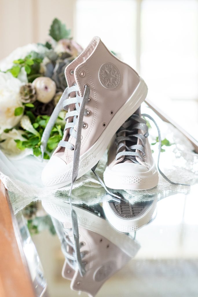 Westchester wedding photography at a beautiful outdoor and indoor venue called Crabtree's Kittle House. Photos by Mikkel Paige Photography. The bride style included gold glitter Jimmy Choo shoes and pink and silver Converse high tops she changed into for the reception. #mikkelpaige #westchestervenue #westchesterphotography #crabtreeskittlehouse #weddingshoes #bridestyle #summerwedding #ConverseSneakers #PinkConverse #HighTops #ReceptionShoes