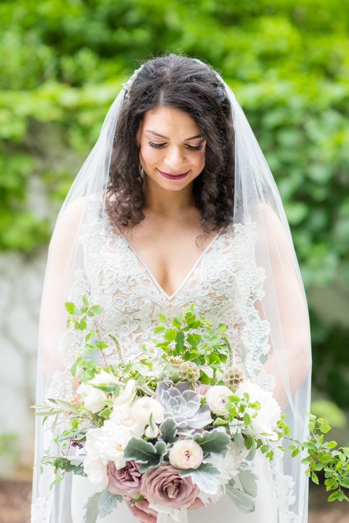 Westchester wedding photography at a beautiful outdoor and indoor venue called Crabtree's Kittle House. Photos by Mikkel Paige Photography. The bride's style was classic, wearing a deep v-neck lace gown by Paloma Blanca from Kleinfeld Bridal and white veil with lace edge. #mikkelpaige #westchestervenue #westchesterphotography #crabtreeskittlehouse #laceweddingdress #summerwedding #bridestyle