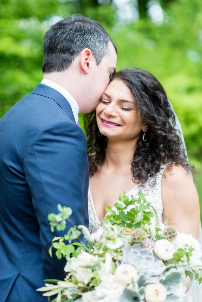 Westchester wedding photography at a beautiful outdoor and indoor venue called Crabtree's Kittle House. Photos by Mikkel Paige Photography. The bride and groom looked classic in a blue suit and v-neck summer lace gown with a deep back. They had a bouquet and boutonniere with poppy pods, scabiosas and roses in a purple + green palette. #mikkelpaige #westchestervenue #westchesterphotography #crabtreeskittlehouse #bridestyle #Maywedding #brideandgroom