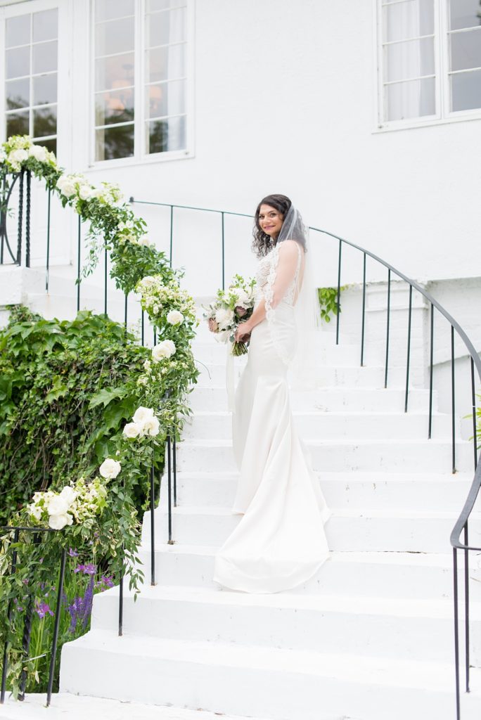 Westchester wedding photography at a beautiful outdoor and indoor venue called Crabtree's Kittle House. Photos by Mikkel Paige Photography. The bride's style was classic, wearing a deep v-neck lace gown by Paloma Blanca from Kleinfeld Bridal. #mikkelpaige #westchestervenue #westchesterphotography #crabtreeskittlehouse #laceweddingdress #summerwedding
