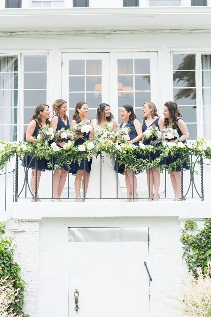 Westchester wedding photography at a beautiful outdoor and indoor venue called Crabtree's Kittle House. Photos by Mikkel Paige Photography. The bridesmaids wore midnight blue short chiffon dresses for the May Memorial Day Weekend wedding and carried purple and green bouquets by Denise Fasanello. #mikkelpaige #westchestervenue #westchesterphotography #crabtreeskittlehouse #bluebridesmaids #summerwedding