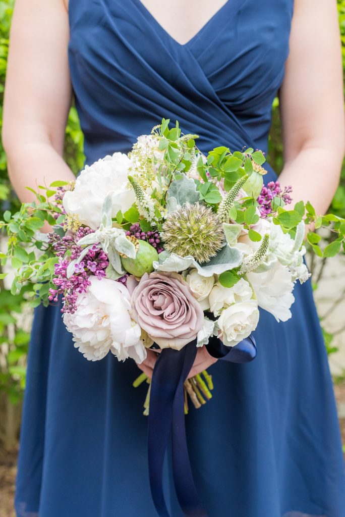 Westchester wedding photography at a beautiful outdoor and indoor venue called Crabtree's Kittle House. Photos by Mikkel Paige Photography. The bridesmaids wore midnight blue short chiffon dresses for the May Memorial Day Weekend wedding and carried purple and green bouquets by Denise Fasanello. #mikkelpaige #westchestervenue #westchesterphotography #crabtreeskittlehouse #bluebridesmaids #summerwedding