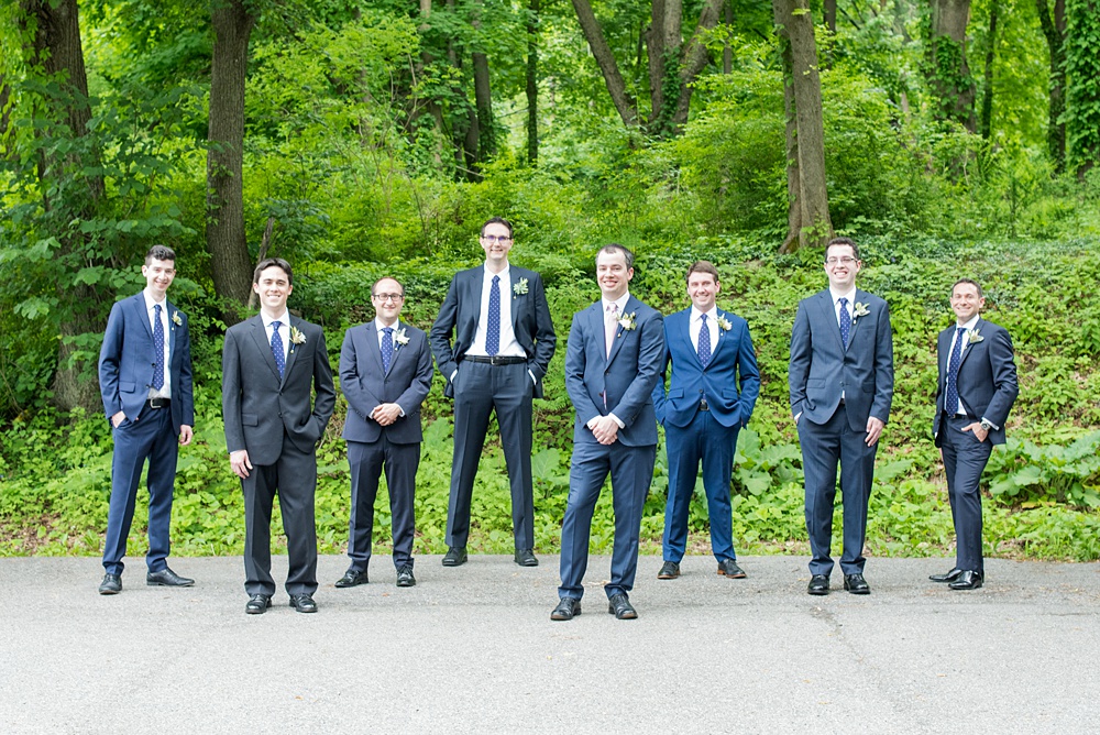 Westchester wedding photography at a beautiful outdoor and indoor venue called Crabtree's Kittle House. Photos by Mikkel Paige Photography. The groomsmen wore blue suits and brown shoes, with mismatched boutonnieres with poppy pods, scabiosa pods, roses and eucalyptus by Denise Fasanello for a May Memorial Day Weekend celebration. #mikkelpaige #westchestervenue #westchesterphotography #crabtreeskittlehouse #groomsmen #mismatchedboutonnieres #poppies #summerwedding