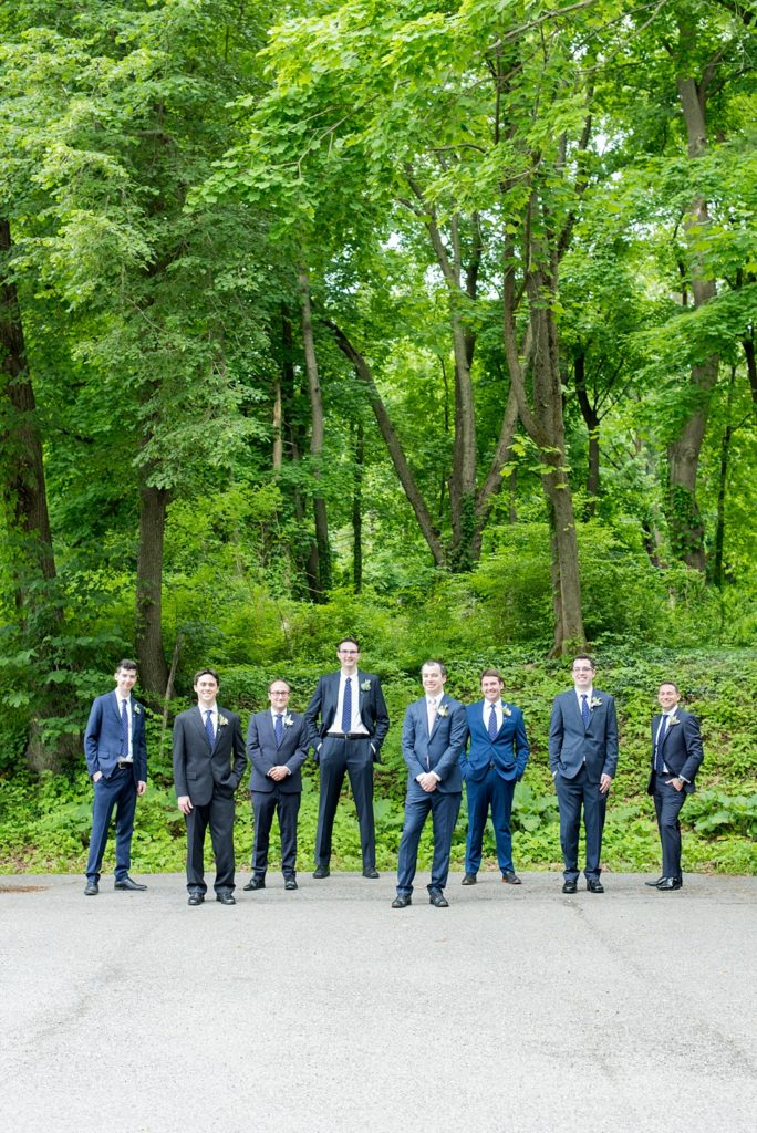 Westchester wedding photography at a beautiful outdoor and indoor venue called Crabtree's Kittle House. Photos by Mikkel Paige Photography. The groomsmen wore blue suits and brown shoes, with mismatched boutonnieres with poppy pods, scabiosa pods, roses and eucalyptus by Denise Fasanello for a May Memorial Day Weekend celebration. #mikkelpaige #westchestervenue #westchesterphotography #crabtreeskittlehouse #groomsmen #mismatchedboutonnieres #poppies #summerwedding