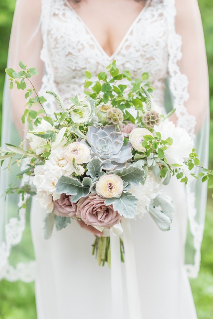 Westchester wedding photography at a beautiful outdoor and indoor venue called Crabtree's Kittle House. Photos by Mikkel Paige Photography. The bride's style was classic, wearing a deep v-neck lace gown by Paloma Blanca from Kleinfeld Bridal and white veil with lace edge. #mikkelpaige #westchestervenue #westchesterphotography #crabtreeskittlehouse #laceweddingdress #summerwedding #bridestyle