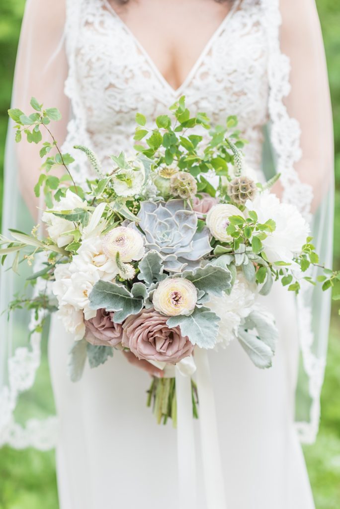 Westchester wedding photography at a beautiful outdoor and indoor venue called Crabtree's Kittle House. Photos by Mikkel Paige Photography. The bride's style was classic, wearing a deep v-neck lace gown by Paloma Blanca from Kleinfeld Bridal and white veil with lace edge. #mikkelpaige #westchestervenue #westchesterphotography #crabtreeskittlehouse #laceweddingdress #summerwedding #bridestyle