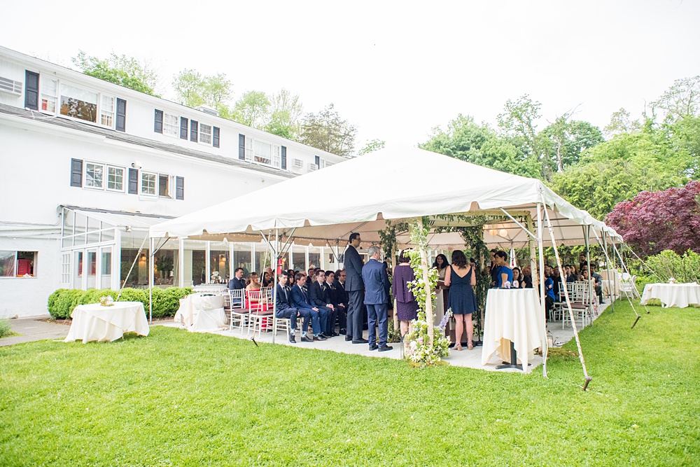 Westchester wedding photography at a beautiful outdoor and indoor venue called Crabtree's Kittle House. Photos by Mikkel Paige Photography. Their tented ceremony had Jewish traditions like breaking of a glass and their friend officiated. #mikkelpaige #westchestervenue #westchesterphotography #crabtreeskittlehouse #summerwedding #weddingceremony #weddingtent