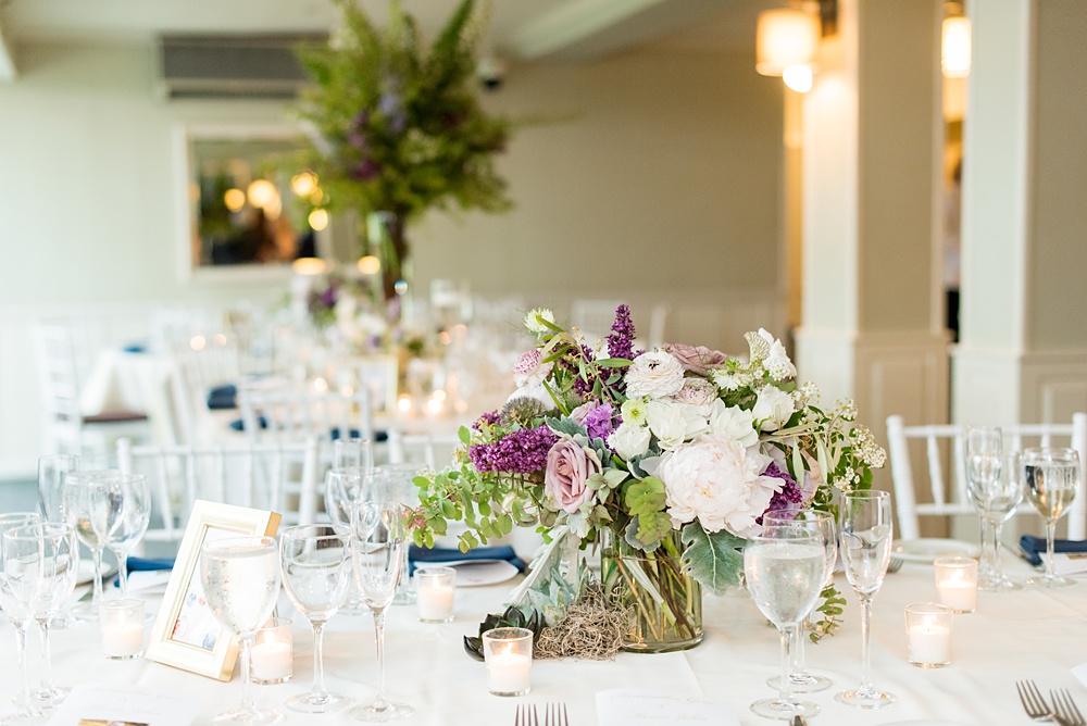 Pictures by Mikkel Paige Photography at the Westchester wedding venue, Crabtree's Kittle House. The ceremony was tented, photos outdoor and reception inside. Purple and white flowers with greenery were centerpieces in the intimate space including Pitcher Plants, ranunculus and roses. #mikkelpaige #westchestervenue #westchesterphotography #crabtreeskittlehouse #summerwedding #receptionspace #eventreception #purplewedding #purplepalette