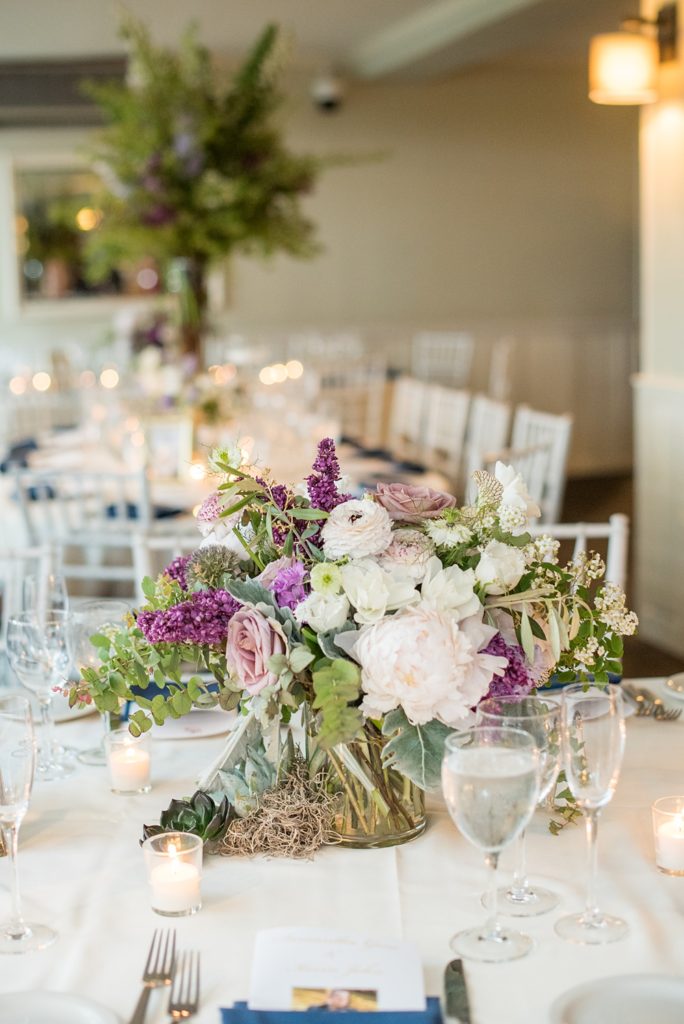 Pictures by Mikkel Paige Photography at the Westchester wedding venue, Crabtree's Kittle House. The ceremony was tented, photos outdoor and reception inside. Purple and white flowers with greenery were centerpieces in the intimate space including Pitcher Plants, ranunculus and roses. #mikkelpaige #westchestervenue #westchesterphotography #crabtreeskittlehouse #summerwedding #receptionspace #eventreception #purplewedding #purplepalette