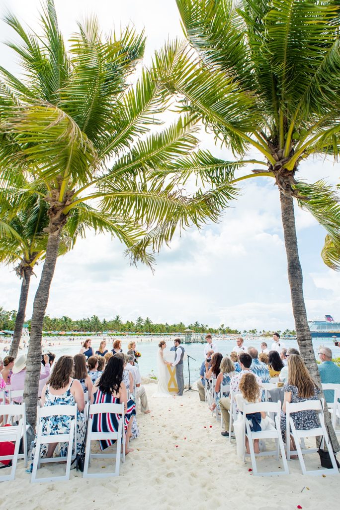 Disney Cruise Line destination wedding photos on Castaway Cay and the Disney Dream ship by Mikkel Paige Photography. This fairy tale wedding make the bride and groom's dream come true to get married in a fun location, spotlighting their love for the brand. Their ceremony was on the beach with the ship in the distance and aqua water nearby in the Bahamas. #mikkelpaige #disneywedding #disneyfairytalewedding #disneycruiseline #disneycruiselinewedding #disneydream #cruisewedding