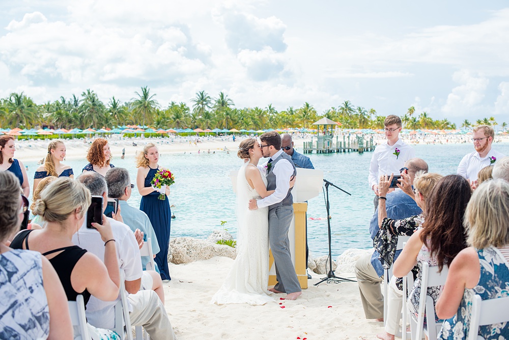 Disney Cruise Line destination wedding photos on Castaway Cay and the Disney Dream ship by Mikkel Paige Photography. This fairy tale wedding make the bride and groom's dream come true to get married in a fun location, spotlighting their love for the brand. Their ceremony was on the beach with the ship in the distance and aqua water nearby in the Bahamas. #mikkelpaige #disneywedding #disneyfairytalewedding #disneycruiseline #disneycruiselinewedding #disneydream #cruisewedding