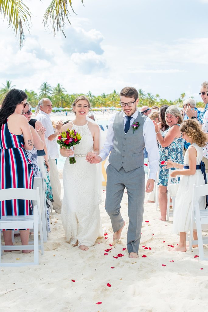 Disney Cruise Line destination wedding photos on Castaway Cay and the Disney Dream ship by Mikkel Paige Photography. This fairy tale wedding make the bride and groom's dream come true to get married in a fun location, spotlighting their love for the brand. Their ceremony was on the beach with the ship in the distance and aqua water nearby in the Bahamas. #mikkelpaige #disneywedding #disneyfairytalewedding #disneycruiseline #disneycruiselinewedding #disneydream #cruisewedding