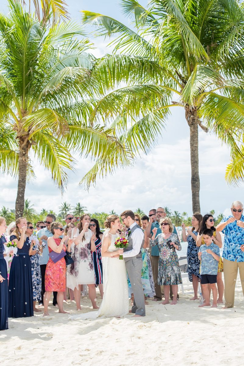 Disney Cruise Line destination wedding photos on Castaway Cay and the Disney Dream ship by Mikkel Paige Photography. This fairy tale wedding make the bride and groom's dream come true to get married in a fun location, spotlighting their love for the brand. Their ceremony was on the beach with the ship in the distance and aqua water nearby in the Bahamas. #mikkelpaige #disneywedding #disneyfairytalewedding #disneycruiseline #disneycruiselinewedding #disneydream #cruisewedding