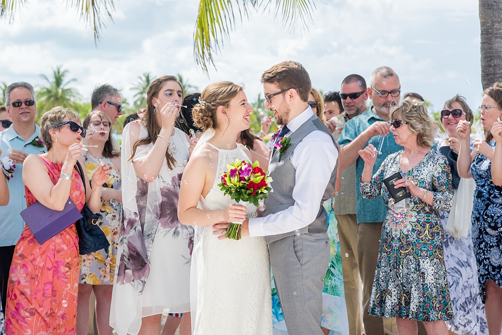 Disney Cruise Line destination wedding photos on Castaway Cay and the Disney Dream ship by Mikkel Paige Photography. This fairy tale wedding make the bride and groom's dream come true to get married in a fun location, spotlighting their love for the brand. Their ceremony was on the beach with the ship in the distance and aqua water nearby in the Bahamas. #mikkelpaige #disneywedding #disneyfairytalewedding #disneycruiseline #disneycruiselinewedding #disneydream #cruisewedding