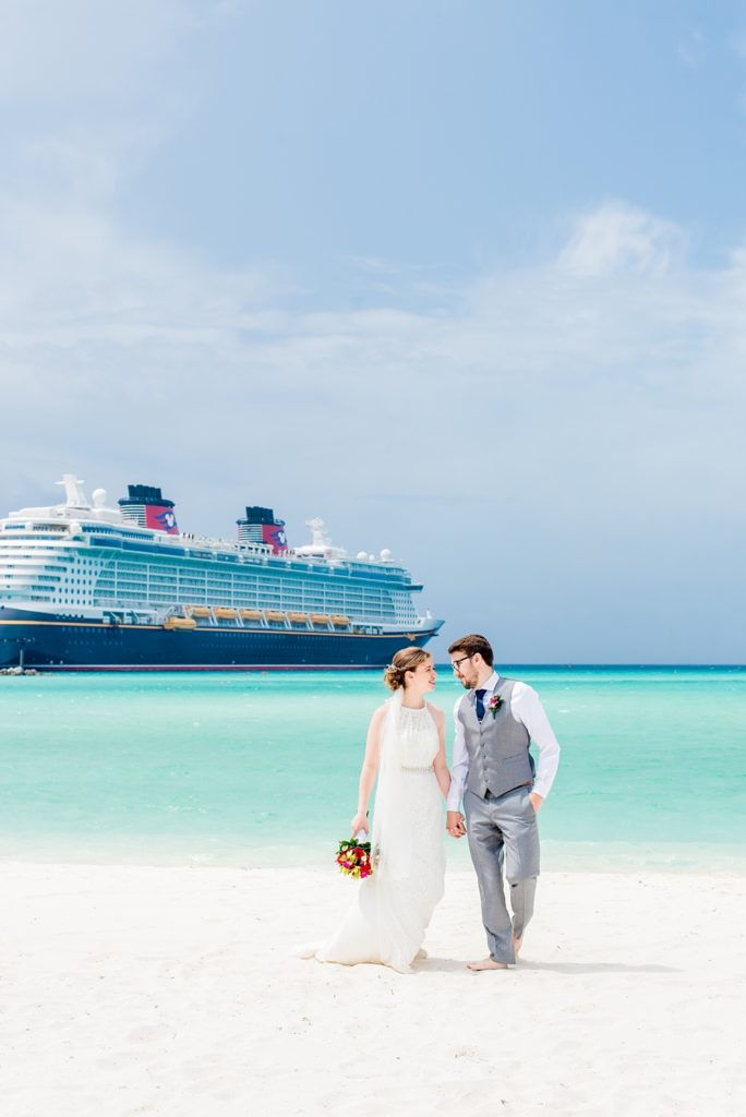 Disney Cruise Line destination wedding photos on Castaway Cay and the Disney Dream ship by Mikkel Paige Photography. This fairy tale wedding make the bride and groom's dream come true to get married in a fun location, spotlighting their love for the brand. Their ceremony was on the beach with the ship in the distance and aqua water nearby in the Bahamas. #mikkelpaige #disneywedding #disneyfairytalewedding #disneycruiseline #disneycruiselinewedding #disneydream #cruisewedding