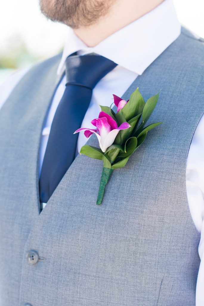 Disney Cruise Line destination wedding photos on Castaway Cay and the Disney Dream ship by Mikkel Paige Photography. This fairy tale wedding make the bride and groom's dream come true to get married in a fun location, spotlighting their love for the brand. The groom wore a purple orchid boutonniere. #mikkelpaige #disneywedding #disneyfairytalewedding #disneycruiseline #disneycruiselinewedding #disneydream #cruisewedding