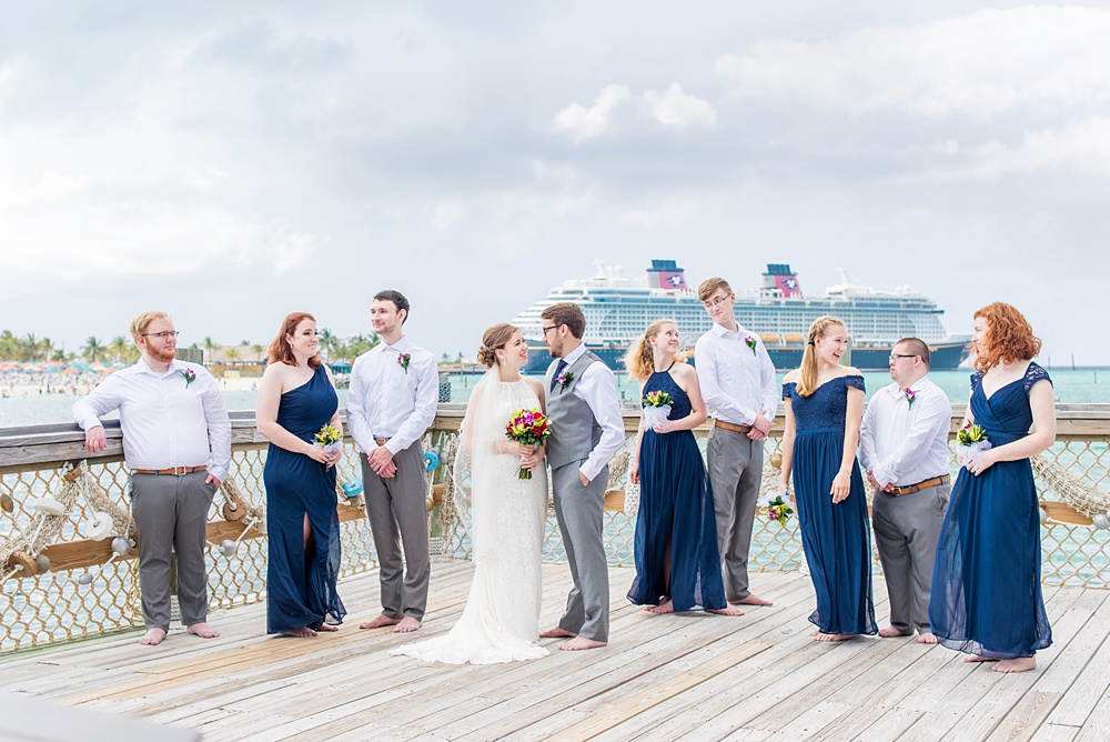 Disney Cruise Line destination wedding photos on Castaway Cay and the Disney Dream ship by Mikkel Paige Photography. This fairy tale wedding make the bride and groom's dream come true to get married in a fun location, spotlighting their love for the brand. Their ceremony was on the beach with the ship in the distance and aqua water nearby in the Bahamas. #mikkelpaige #disneywedding #disneyfairytalewedding #disneycruiseline #disneycruiselinewedding #disneydream #cruisewedding