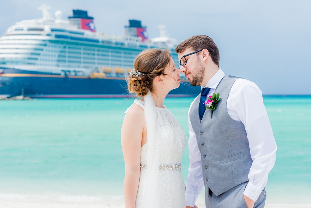 Disney Cruise Line destination wedding photos on Castaway Cay and the Disney Dream ship by Mikkel Paige Photography. This fairy tale wedding make the bride and groom's dream come true to get married in a fun location, spotlighting their love for the brand. Their ceremony was on the beach with the ship in the distance and aqua water nearby in the Bahamas. #mikkelpaige #disneywedding #disneyfairytalewedding #disneycruiseline #disneycruiselinewedding #disneydream #cruisewedding