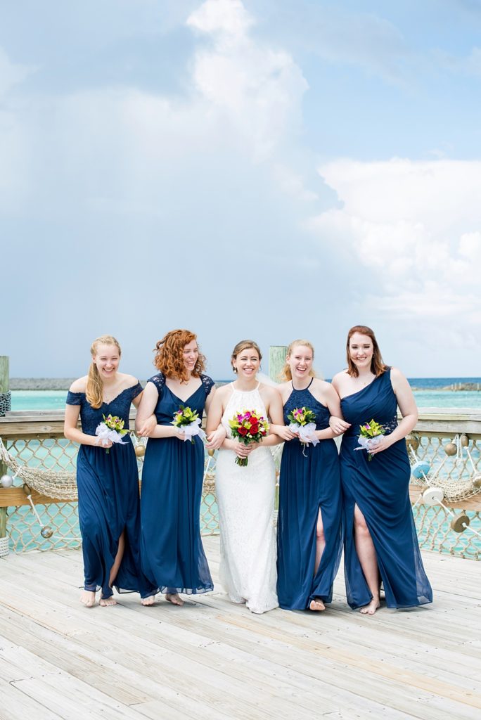 Disney Cruise Line destination wedding photos on Castaway Cay and the Disney Dream ship by Mikkel Paige Photography. This fairy tale wedding make the bride and groom's dream come true to get married in a fun location, spotlighting their love for the brand. Their ceremony was on the beach with the ship in the distance and aqua water nearby in the Bahamas. #mikkelpaige #disneywedding #disneyfairytalewedding #disneycruiseline #disneycruiselinewedding #disneydream #cruisewedding