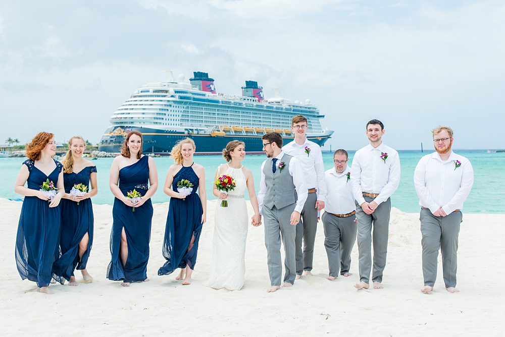 Disney Cruise Line destination wedding photos on Castaway Cay and the Disney Dream ship by Mikkel Paige Photography. This fairy tale wedding make the bride and groom's dream come true to get married in a fun location, spotlighting their love for the brand. Their ceremony was on the beach with the ship in the distance and aqua water nearby in the Bahamas. #mikkelpaige #disneywedding #disneyfairytalewedding #disneycruiseline #disneycruiselinewedding #disneydream #cruisewedding