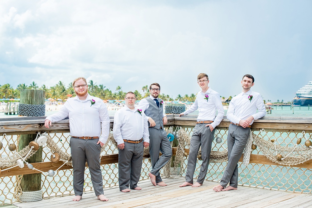 Disney Cruise Line destination wedding photos on Castaway Cay and the Disney Dream ship by Mikkel Paige Photography. This fairy tale wedding make the bride and groom's dream come true to get married in a fun location, spotlighting their love for the brand. Their ceremony was on the beach with the ship in the distance and aqua water nearby in the Bahamas. #mikkelpaige #disneywedding #disneyfairytalewedding #disneycruiseline #disneycruiselinewedding #disneydream #cruisewedding