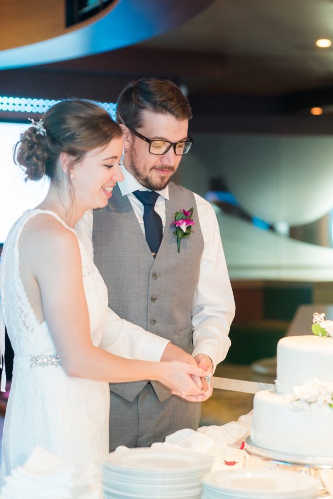 Disney Cruise Line destination wedding photos on Castaway Cay and the Disney Dream ship by Mikkel Paige Photography. This fairy tale wedding make the bride and groom's dream come true to get married in a fun location, spotlighting their love for the brand. Their reception was in the D Lounge with Fairy Tale Celebration champagne and a white fondant cake. #mikkelpaige #disneywedding #disneyfairytalewedding #disneycruiseline #disneycruiselinewedding #disneydream #cruisewedding