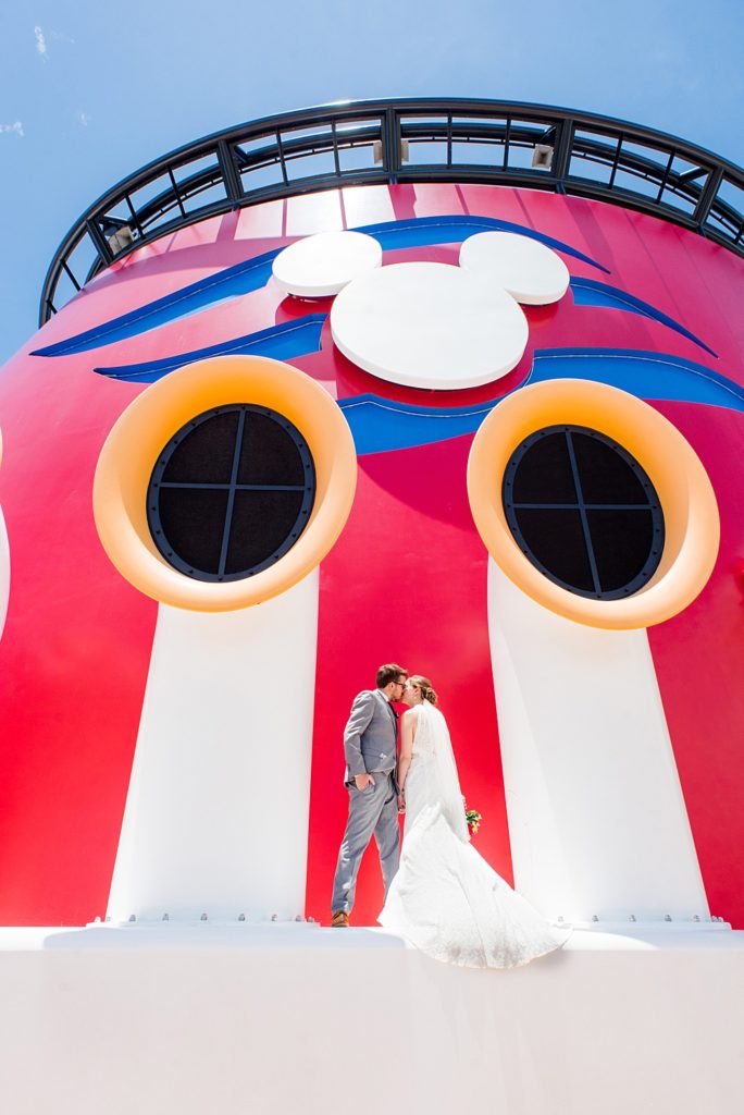 Disney Cruise Line destination wedding photos on Castaway Cay and the Disney Dream ship by Mikkel Paige Photography. This fairy tale wedding make the bride and groom's dream come true to get married in a fun location, spotlighting their love for the brand. #mikkelpaige #disneywedding #disneyfairytalewedding #disneycruiseline #disneycruiselinewedding #disneydream #cruisewedding