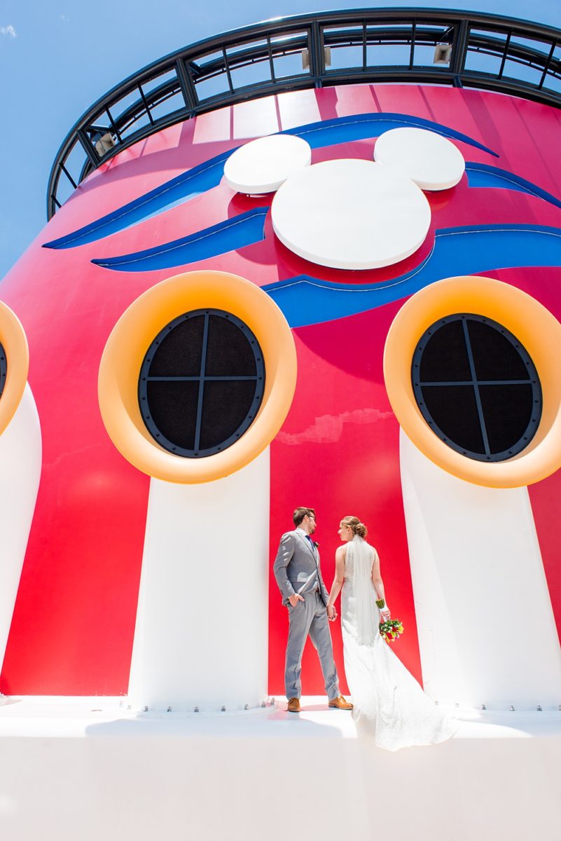 Disney Cruise Line destination wedding photos on Castaway Cay and the Disney Dream ship by Mikkel Paige Photography. This fairy tale wedding make the bride and groom's dream come true to get married in a fun location, spotlighting their love for the brand. #mikkelpaige #disneywedding #disneyfairytalewedding #disneycruiseline #disneycruiselinewedding #disneydream #cruisewedding #velvetringbox