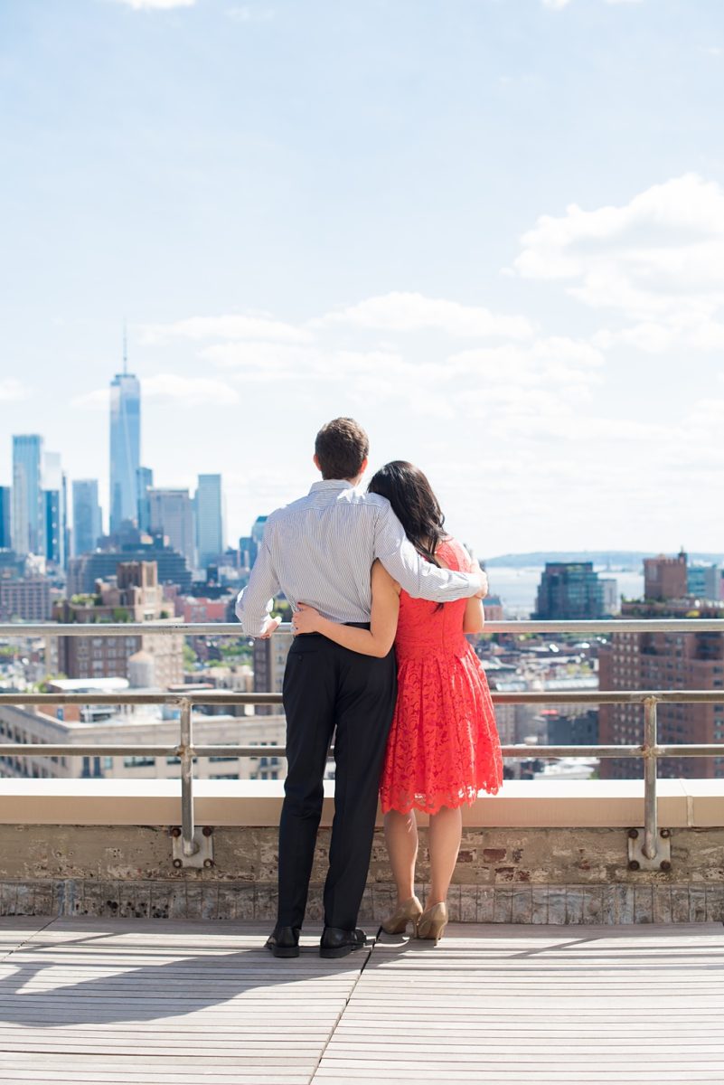 New York City pictures with a beautiful, fun couple with modern style. From a classic round diamond ring to sweet kisses with the Manhattan Skyline, Mikkel Paige Photography took them around western, lower NYC photographing their love at Google headquarters and Washington Square Park for engagement photos. #MikkelPaige #NYCengagementphotos #NewYorkCityEngagementPhotos #NYCengagementpictures