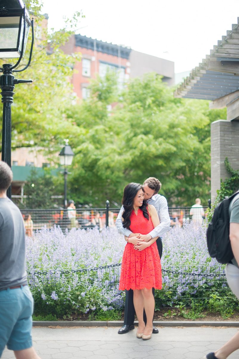 New York City pictures with a beautiful, fun couple with modern style. From a classic round diamond ring to sweet kisses with the Manhattan Skyline, Mikkel Paige Photography took them around western, lower NYC photographing their love at Google headquarters and Washington Square Park for engagement photos. #MikkelPaige #NYCengagementphotos #NewYorkCityEngagementPhotos #NYCengagementpictures