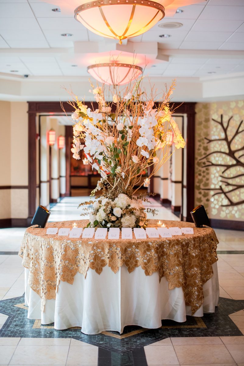 Photographs at New Jersey wedding venue, Temple Emanu-el, by Mikkel Paige Photography, with kosher catering for a golden 50th anniversary celebration. Decor with metallic and white flowers for the romantic space. Fun-loving couple providing beautiful inspiration with cute signs, table numbers and giveaways. All paper and signs by @suitepaperie. #mikkelpaige #newjerseyweddingphotographer #newjerseyweddingvenue #njweddings #njweddingphotographers