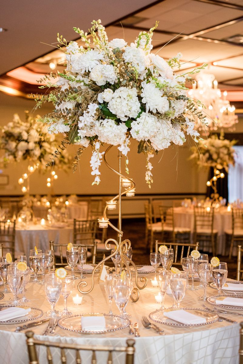 Photographs at New Jersey wedding venue, Temple Emanu-el, by Mikkel Paige Photography, with kosher catering for a golden 50th anniversary celebration. Decor with metallic and white flowers for the romantic space. Fun-loving couple providing beautiful inspiration with cute signs, table numbers and giveaways. All paper and signs by @suitepaperie. #mikkelpaige #newjerseyweddingphotographer #newjerseyweddingvenue #njweddings #njweddingphotographers