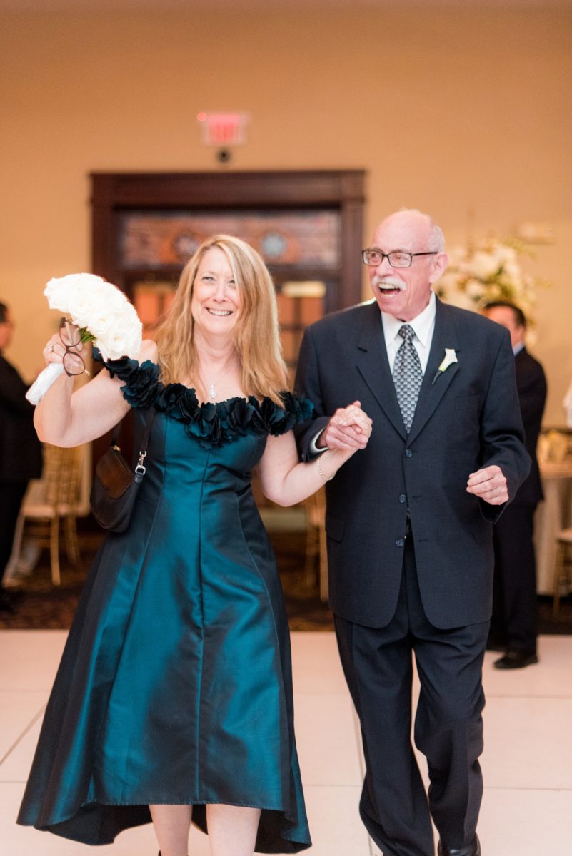 Photographs at New Jersey wedding venue, Temple Emanu-el, by Mikkel Paige Photography, with kosher catering for a golden 50th anniversary celebration. Decor with metallic and white flowers for the romantic space. Fun-loving couple providing beautiful inspiration with cute signs, table numbers and giveaways. All paper and signs by @suitepaperie. #mikkelpaige #newjerseyweddingphotographer #newjerseyweddingvenue #njweddings #njweddingphotographers