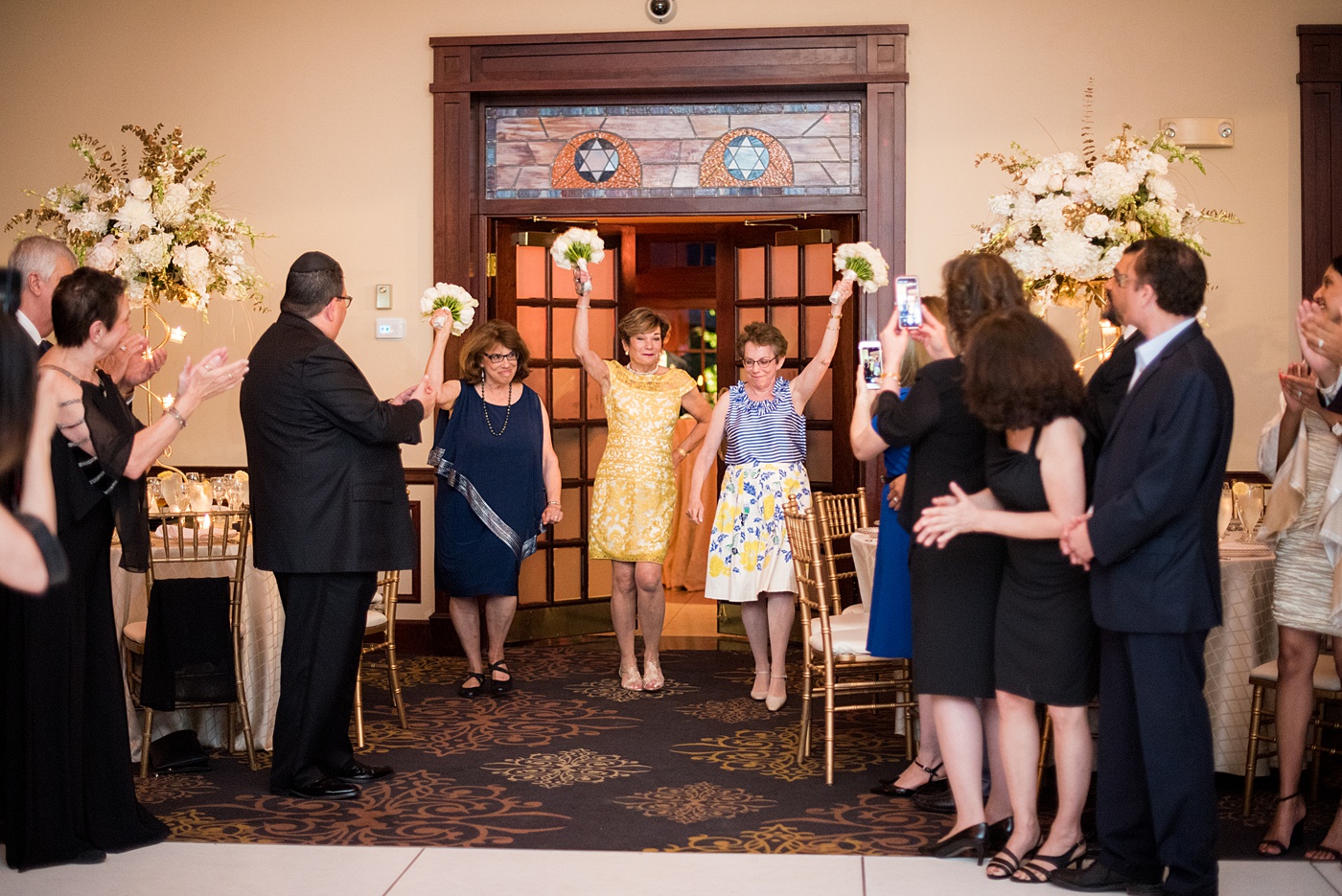 Photographs at New Jersey wedding venue, Temple Emanu-el, by Mikkel Paige Photography, with kosher catering for a golden 50th anniversary celebration. Decor with metallic and white flowers for the romantic space. Fun-loving couple providing beautiful inspiration with cute signs, table numbers and giveaways. All paper and signs by @suitepaperie. #mikkelpaige #newjerseyweddingphotographer #newjerseyweddingvenue #njweddings #njweddingphotographers