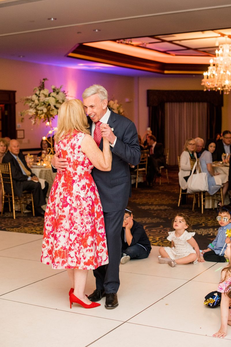 Photographs at New Jersey wedding venue, Temple Emanu-el, by Mikkel Paige Photography, with kosher catering for a golden 50th anniversary celebration. Decor with metallic and white flowers for the romantic space. Fun-loving couple providing beautiful inspiration with cute signs, table numbers and giveaways. All paper and signs by @suitepaperie. #mikkelpaige #newjerseyweddingphotographer #newjerseyweddingvenue #njweddings #njweddingphotographers