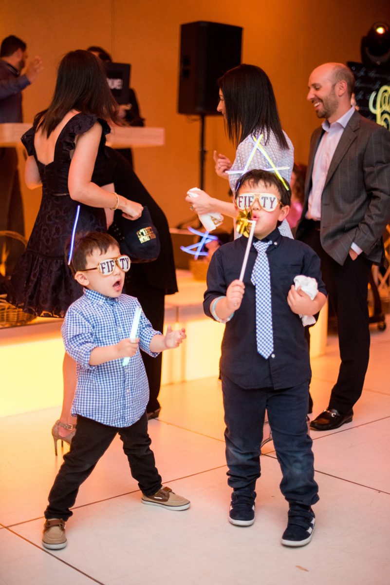 Photographs at New Jersey wedding venue, Temple Emanu-el, by Mikkel Paige Photography, with kosher catering for a golden 50th anniversary celebration. Decor with metallic and white flowers for the romantic space. Fun-loving couple providing beautiful inspiration with cute signs, table numbers and giveaways. All paper and signs by @suitepaperie. #mikkelpaige #newjerseyweddingphotographer #newjerseyweddingvenue #njweddings #njweddingphotographers