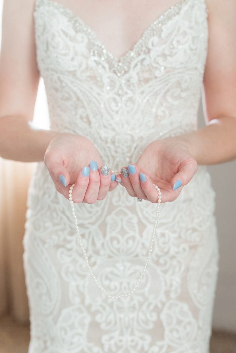 Pictures at a Durham, North Carolina wedding venue by Mikkel Paige Photography. The Rickhouse was a perfect indoor space for the bride and groom's ceremony + reception. The bride got ready at 21c Museum hotel and Mikkel Paige photographed details including rings, veil, dress and heirloom pearl necklace from the bride's grandmother. #mikkelpaige #therickhouse #durhamweddingphotos #durhamwedding #northcarolinaweddingphotographer #durhamweddingphotographer #pearls #familyheirloom