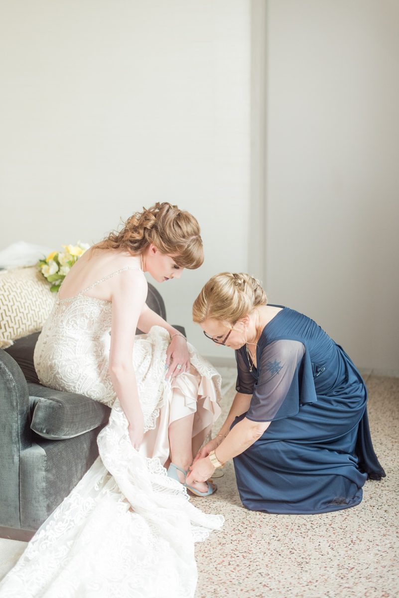 Pictures at a Durham, North Carolina wedding venue by Mikkel Paige Photography. The Rickhouse was a perfect indoor space for the bride and groom's ceremony + reception. The bride got ready at 21c Museum hotel and Mikkel Paige photographed details including perfume, rings, veil and blue shoes. #mikkelpaige #therickhouse #durhamweddingphotos #durhamwedding #northcarolinaweddingphotographer #durhamweddingphotographer #blueshoes #ringphotos #velvetringbox