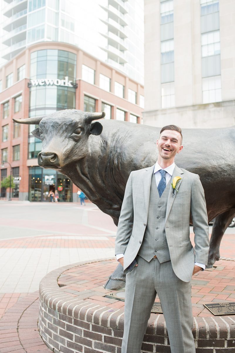 Pictures at a Durham, North Carolina wedding venue by Mikkel Paige Photography. The Rickhouse was the perfect indoor space for the ceremony + reception. The couple got ready at 21c Museum hotel and took beautiful outdoor photos. Groom chose yellow for a calla lily boutonniere and gray three piece suit with custom liner, blue tie + brown shoes. #mikkelpaige #therickhouse #durhamweddingphotos #durhamwedding #northcarolinaweddingphotographer #durhamweddingphotographer #groomstyle #threepiecesuit