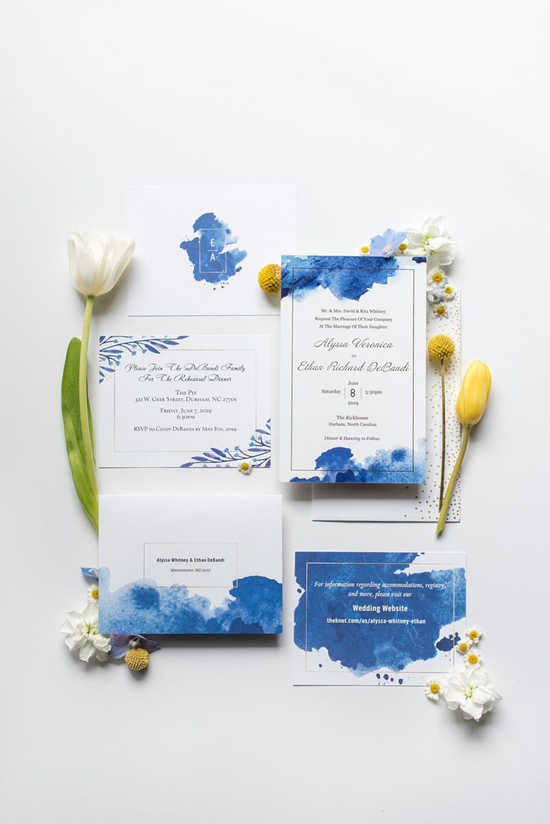 Lay flat pictures from a Durham, North Carolina wedding by Mikkel Paige Photography. The Rickhouse was the perfect indoor space for the bride and groom's ceremony + reception. They got ready at 21c Museum hotel and took beautiful outdoor photos in the summer sun. The bride chose yellow and blue for the decor including their invitations with a watercolor motif and monogram. #mikkelpaige #therickhouse #durhamweddingphotos #durhamwedding #northcarolinaweddingphotographer #durhamweddingphotographer
